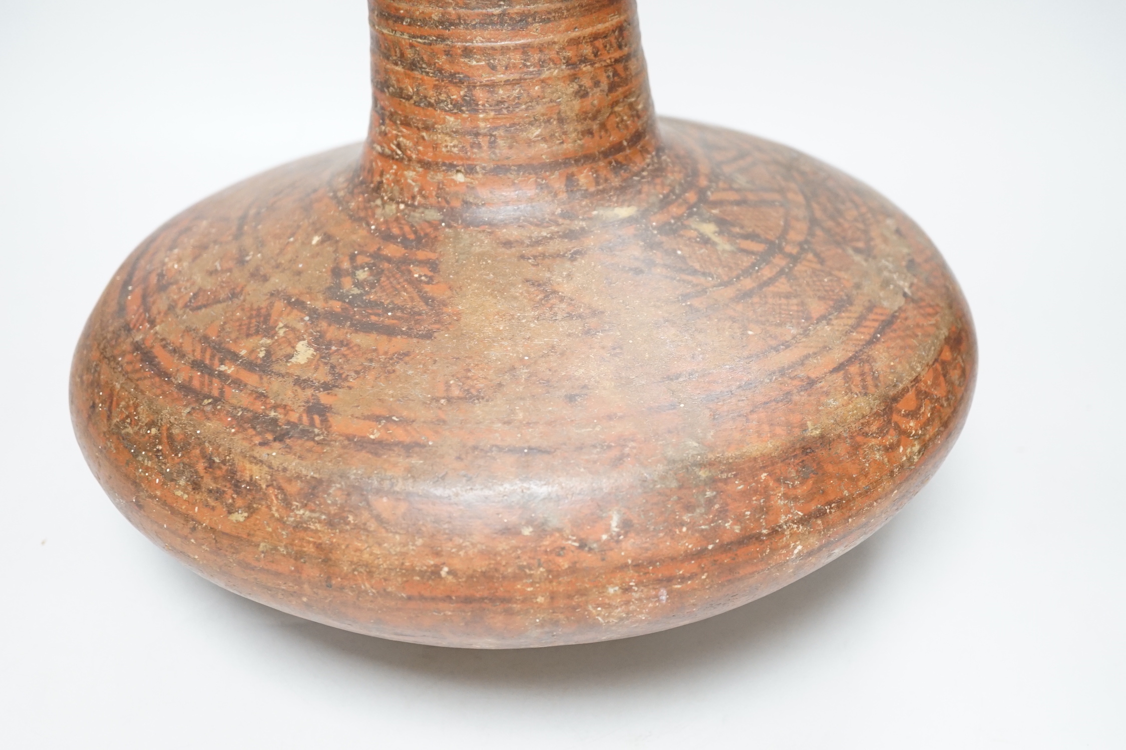 An Indian Rajasthan clay vase hand painted with a geometric design, 30cm high